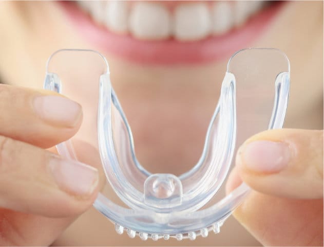 Closeup of woman's hand holding a night guard. 