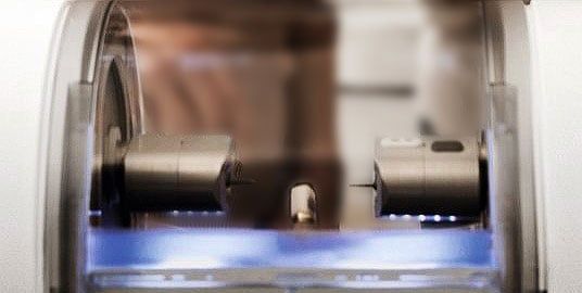 Shot of the CEREC milling machine haven milled a perfect fitting crown to be used as a final restoration.